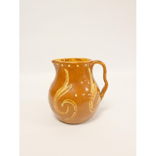 194 - Alfred William Finch (1854-1930). A late Victorian slip glazed pottery jug decorated with yellow och... 