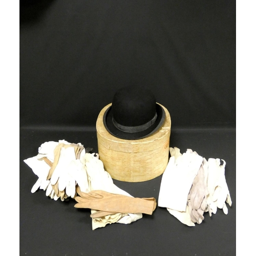 309 - A black bowler hat in card hat box, and a collection of various kid and other leather gloves to incl... 