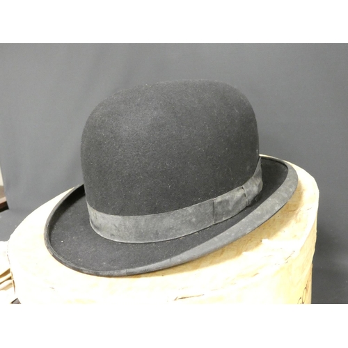 309 - A black bowler hat in card hat box, and a collection of various kid and other leather gloves to incl... 