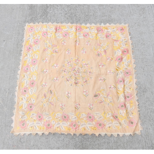 317 - Oriental pink ground table cover embroidered with flowers 120cm x 123cm.