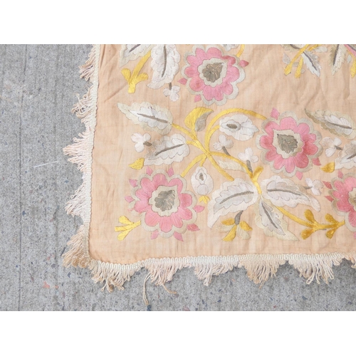 317 - Oriental pink ground table cover embroidered with flowers 120cm x 123cm.