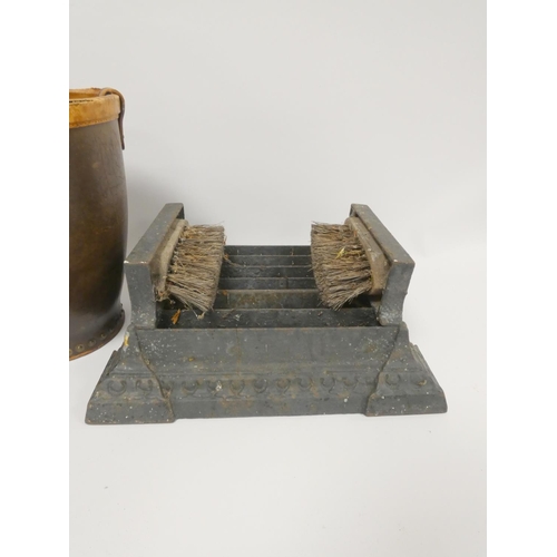 332 - Early 20th century cast iron boot cleaner and a leather fire bucket. (2)