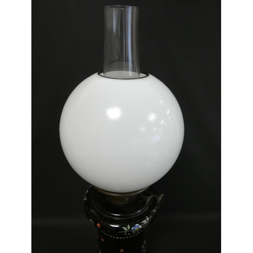 328 - Victorian duplex paraffin table light with opaque milk glass globe, the black glass base decorated w... 