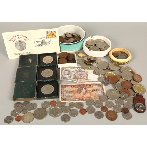 152 - Large assortment of world coins, a note from Thailand and one from Bermuda, etc