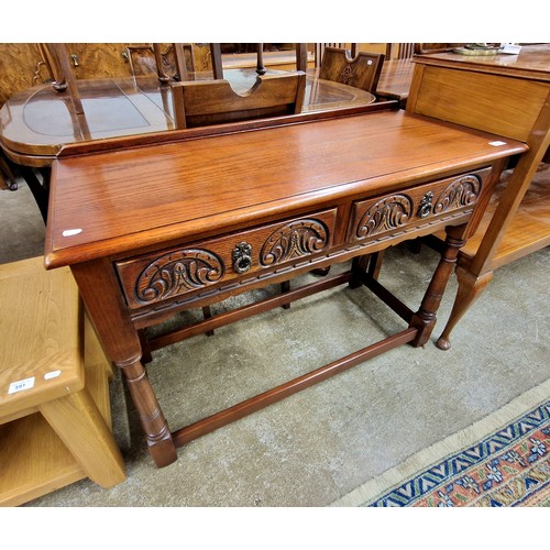 589 - Carved oak hall table with two fitted drawers