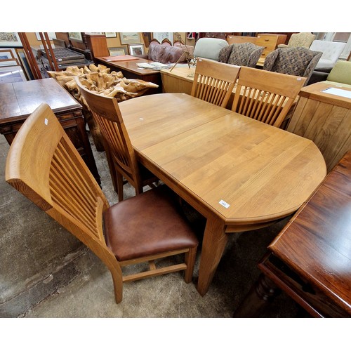 569 - Contemporary oak dining table with four matching chairs and matching sideboard