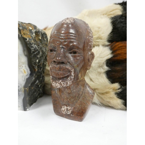 163 - African gazelle hide rug, a carved serpentine bust of a Maasai tribesman and a blue agate geode (3)