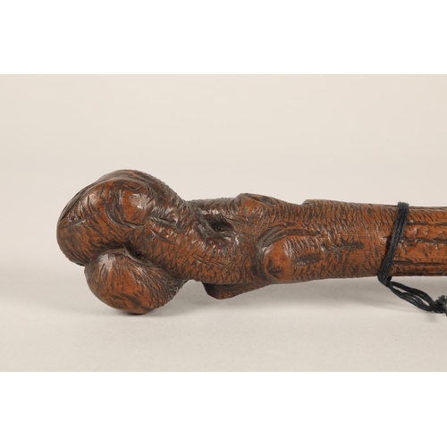 35 - Double ended carved wooden stick with couple embracing at one end, 50cm long