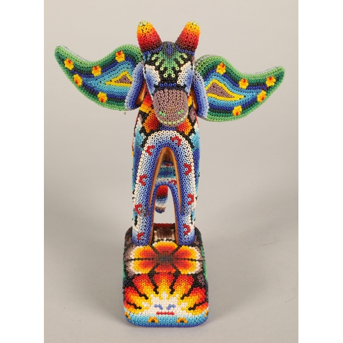 48 - Two Mexican beaded Huichol figures, lizard and winged horse