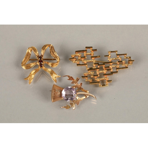 96 - Two 9ct gold brooches including a purple gem set thistle and a red gem set bow, and a mid century mo... 