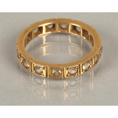 115 - Yellow metal eternity ring set with white gems