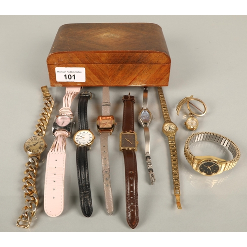 101 - A wooden box containing assorted wristwatches