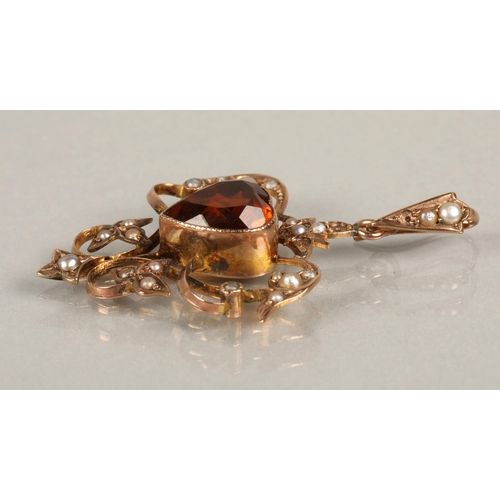 113 - 9kt gold Edwardian style pendant set with seed pearls and a central orange gem in the shape of a hea... 