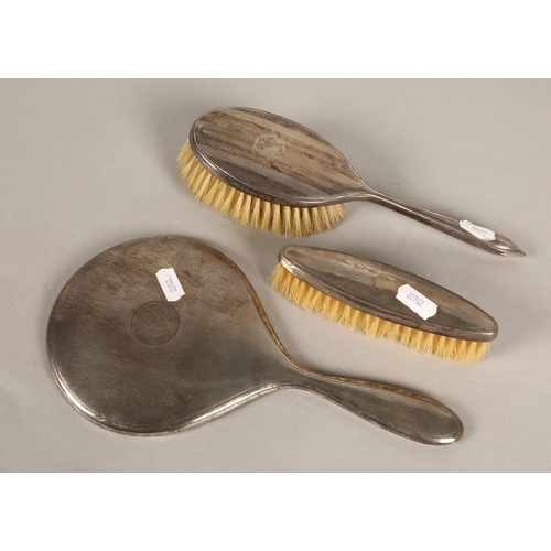 214 - Silver mirror and two piece brush set, hallmarked London 1930, Birmingham 1934 and 1932 respectively