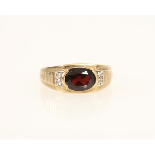 400 - Gents 9ct gold ring set with oval cut garnet and flanking diamonds, size U/V, 3.8g.