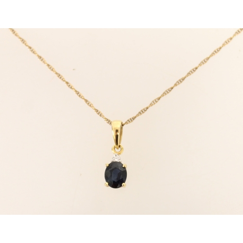 410 - 18ct gold mounted sapphire and diamond pendant on 9ct gold chain, gross 1.5g.