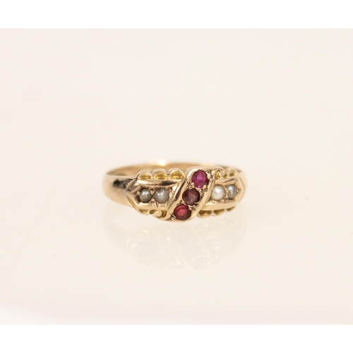 411 - Edwardian 9ct gold ring set with three round cut rubies and flanking seed pearls, size K/L, 1.9g.