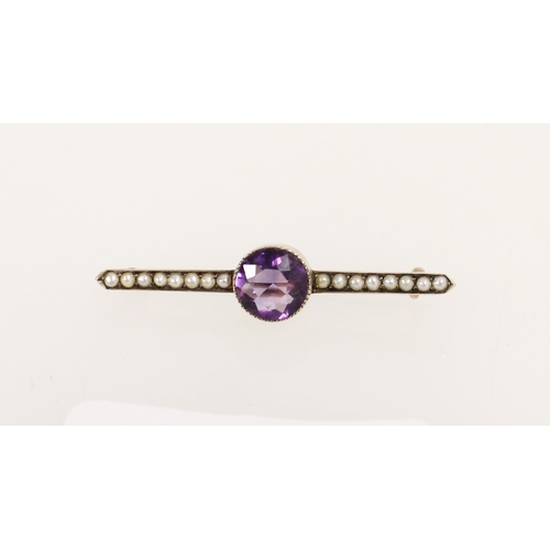 427 - Edwardian yellow metal bar brooch set with round cut amethyst and seed pearls.