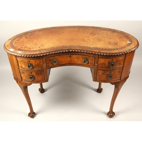 593 - Leather topped mahogany serpentine fronted writing desk raised on ball and claw feet, H 75cm, W 107c... 