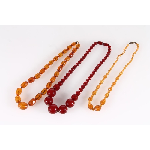 449 - Cherry amber bakelite or Lucite beaded necklace, 34g, together with two other faceted bead necklaces... 