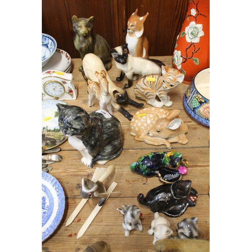 106 - Pottery animal models to include a Tom Raymond model of a standing cat, a Beswick Siamese cat, a USS... 