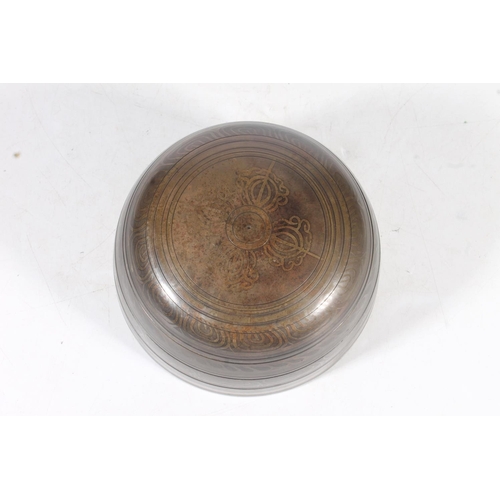 11 - Tibetan bronze singing bowl, with original rush wove base, 15cm.