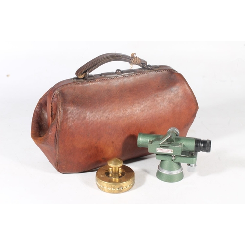 14 - Stanley of London theodolite surveyors instrument, a bowling ball bag, and a brass paperweight.