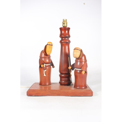 9 - Turned and carved wooden table lamp in the form of two monks.