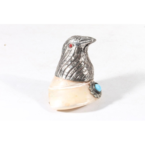 281 - Mother-of-pearl shell box decorated with a white metal raven's head with red glass eyes and blue sto... 