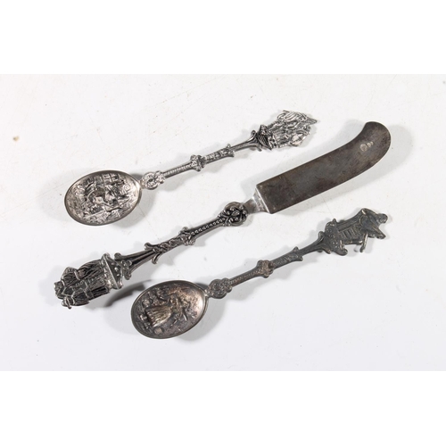 284 - Pair of continental white metal souvenir spoons and a continental butter knife.