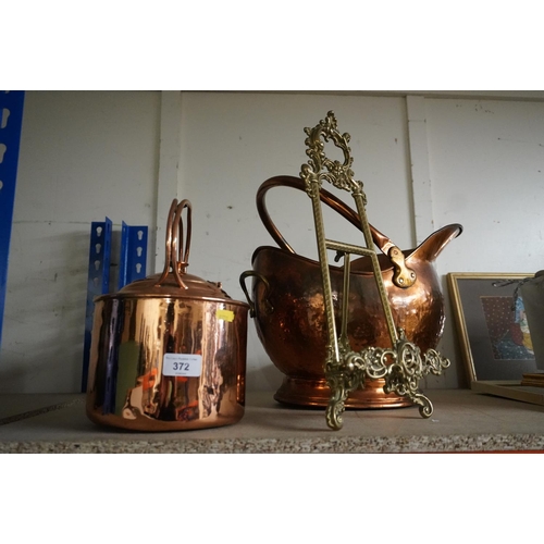 372 - Antique brass easel book stand, a coal scuttle helmet and a copper kettle.