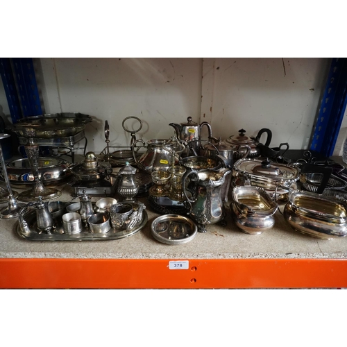 378 - Shelf containing silver plate to include a three piece teaset, napkin rings, candlesticks, coasters,... 