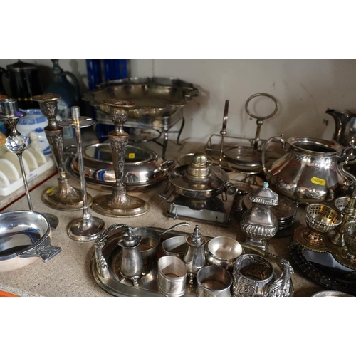 378 - Shelf containing silver plate to include a three piece teaset, napkin rings, candlesticks, coasters,... 