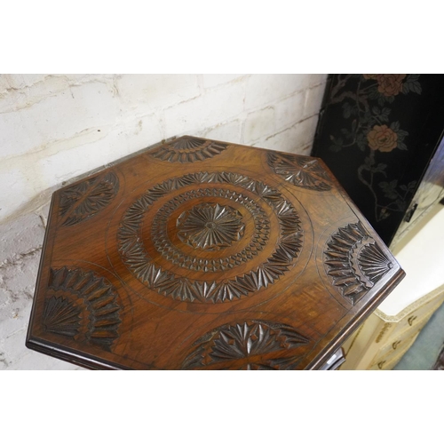 555 - Mahogany occasional table with chip carved hexagonal top, 68cm high.