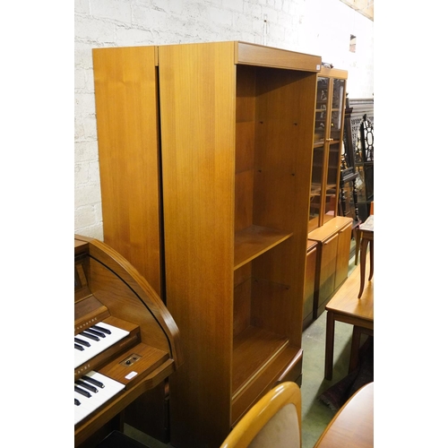 576 - Pair of teak open bookcases with base drawers, 180cm high.