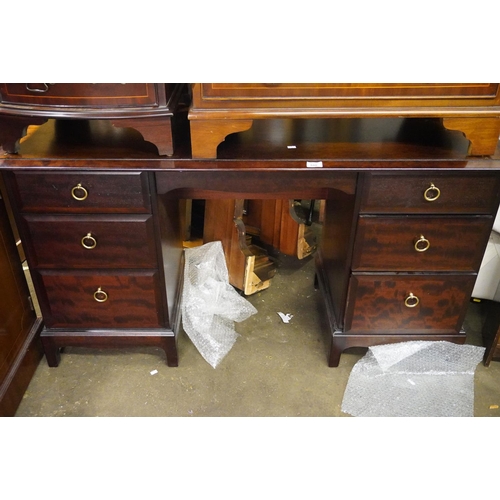 600 - Stag dark wood dressing table, 135cm wide.