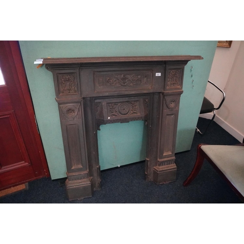 618 - Victorian cast iron fire surround, decorated with urns and floral horns, 110cm wide x 110cm high, in... 