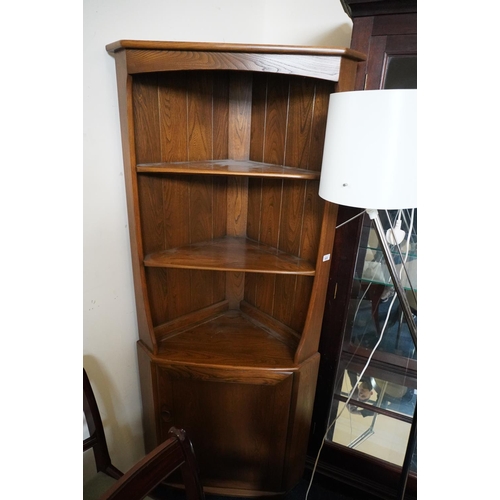 620 - Ercol dark elm corner cabinet, 180cm high.