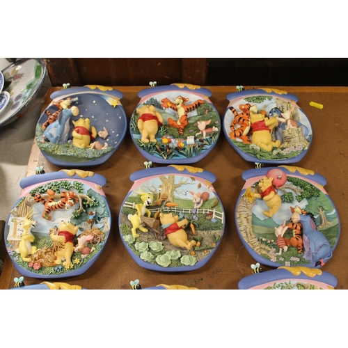 163 - Bradford Exchange Winnie-the-Pooh wall plates and a Winnie-the-Pooh textile wall hanging.