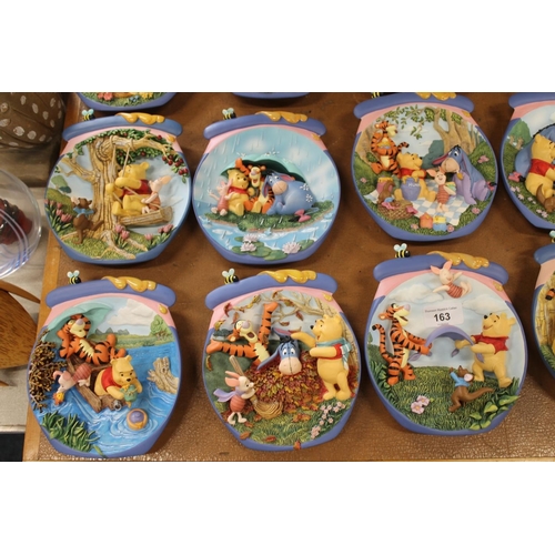 163 - Bradford Exchange Winnie-the-Pooh wall plates and a Winnie-the-Pooh textile wall hanging.