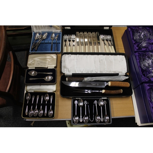 390F - Cased flatware to include a carving set, spoons and tongs, etc.