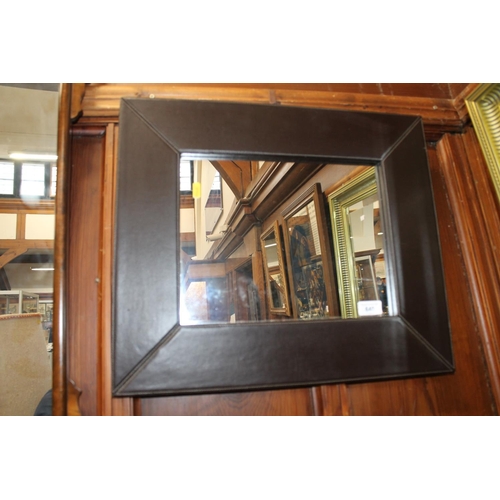 640 - Leather framed wall mirror.