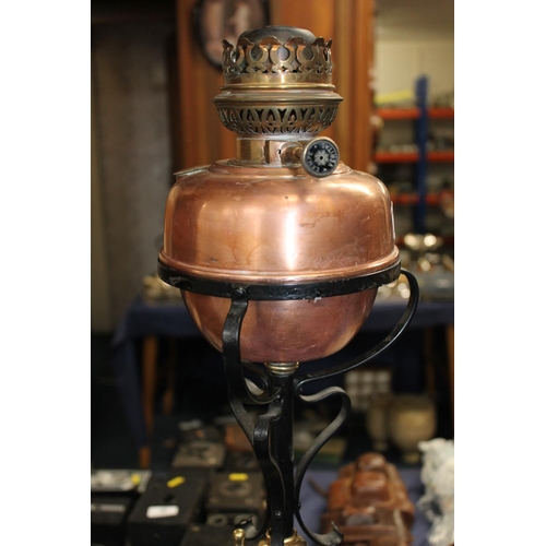 655 - Art Nouveau wrought iron and copper floor standing oil lamp, H148cm.