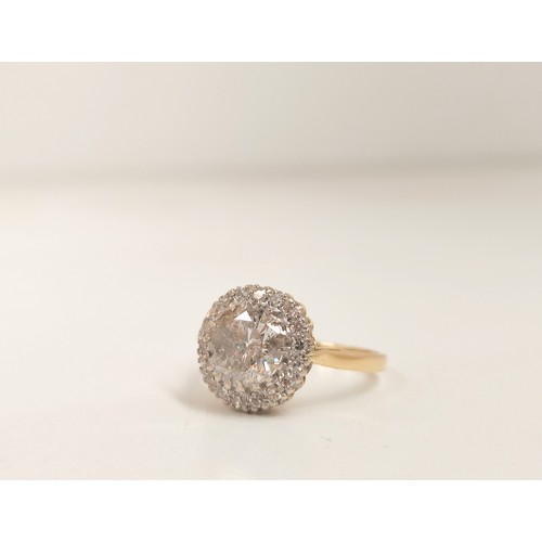 93 - 18ct gold diamond cluster ring, the centre brilliant cut stone measuring 1.6cts, encircled by smalle... 