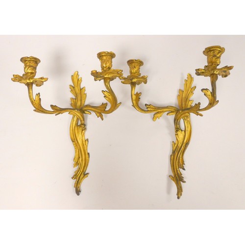 331 - Pair of Italian style gilt metal twin wall sconces, with all over Rococo influence, 39cm high. (2)