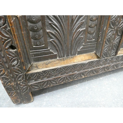 345 - 18th century carved oak coffer of large proportions with hinged top above three panels bearing allov... 