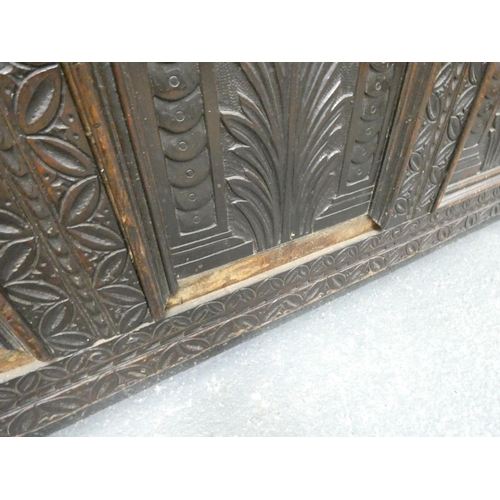 345 - 18th century carved oak coffer of large proportions with hinged top above three panels bearing allov... 