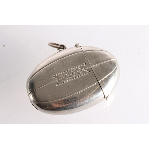 32 - White metal novelty vesta case in the form of a rugby ball.