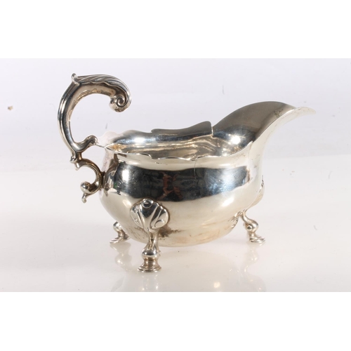 51 - 18th century or possibly earlier, silver sauce boat of typical form with serpentine edge, scroll han... 