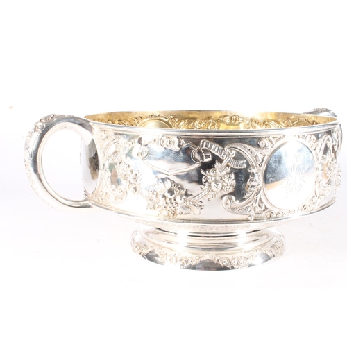 62 - Victorian silver twin handled punch bowl with gilded interior and embossed ornate designs of garland... 